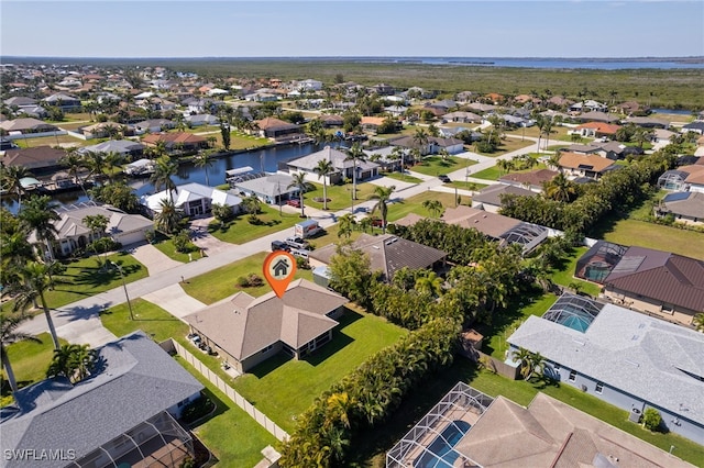 birds eye view of property with a residential view and a water view