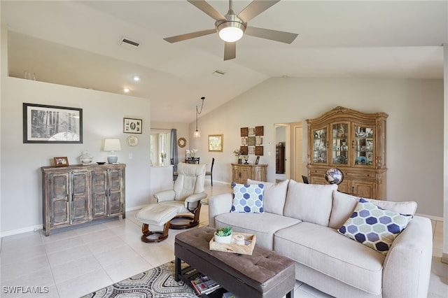 living area featuring light tile patterned floors, visible vents, a ceiling fan, vaulted ceiling, and baseboards