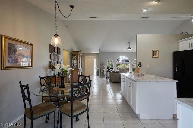 dining space featuring light tile patterned floors, ceiling fan, and visible vents