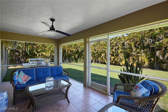 sunroom / solarium with a ceiling fan