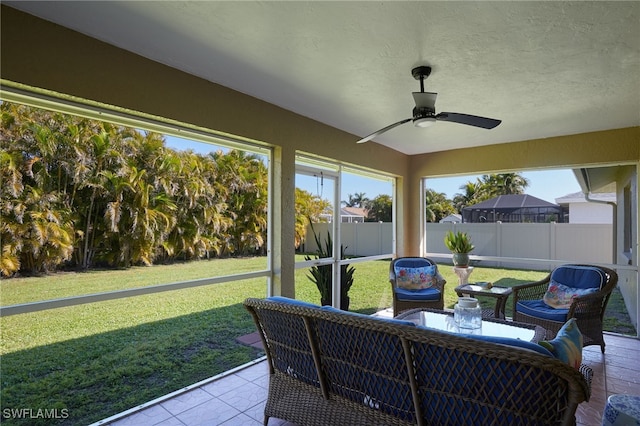 sunroom / solarium featuring ceiling fan