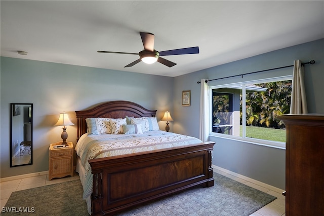 bedroom featuring ceiling fan, baseboards, and light tile patterned floors