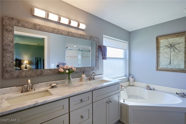 bathroom featuring double vanity, a garden tub, an enclosed shower, and a sink