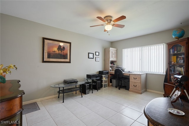 home office featuring a ceiling fan, baseboards, and light tile patterned floors