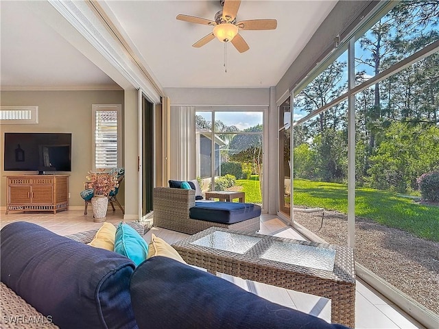 sunroom featuring a ceiling fan