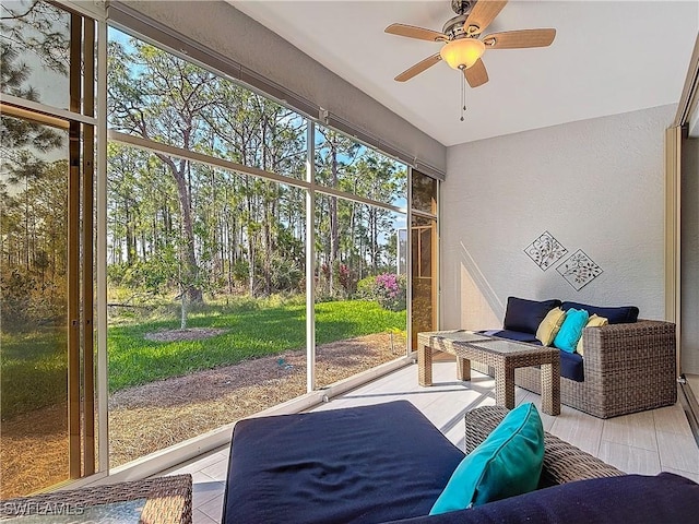 sunroom / solarium featuring ceiling fan