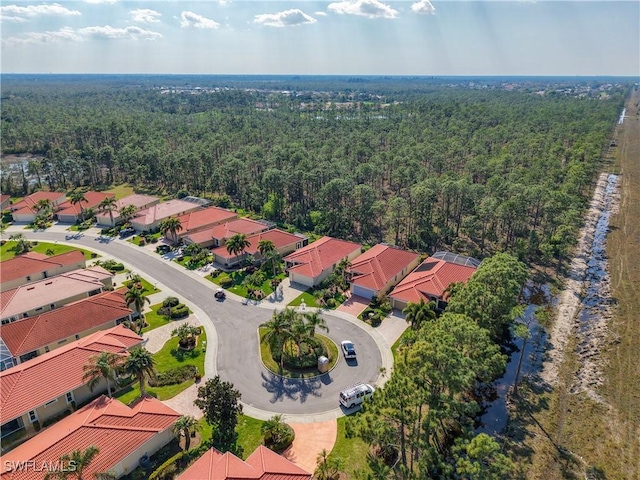 bird's eye view featuring a residential view and a wooded view