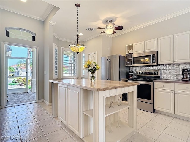 kitchen with open shelves, crown molding, stainless steel appliances, and decorative backsplash