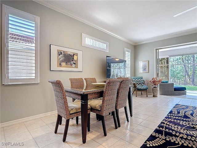 dining space with crown molding, baseboards, and light tile patterned floors