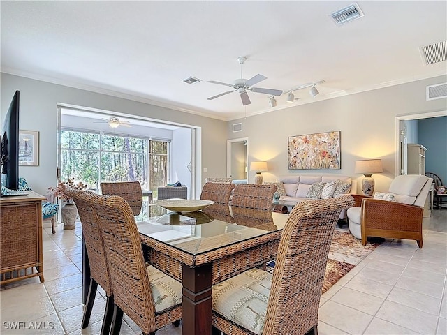 dining room featuring light tile patterned floors, visible vents, and crown molding