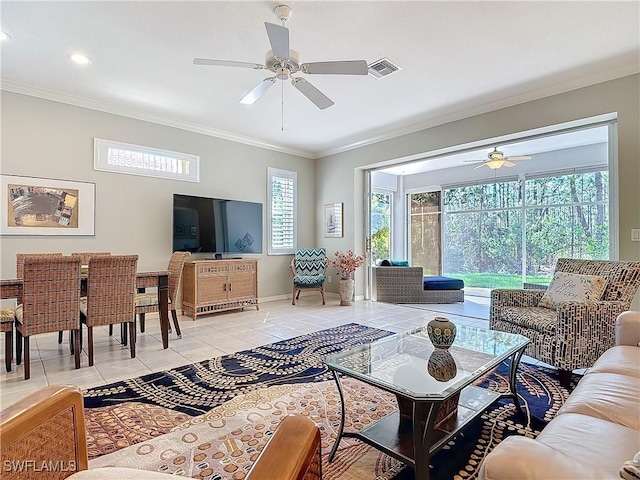 living area with baseboards, visible vents, ornamental molding, and light tile patterned flooring