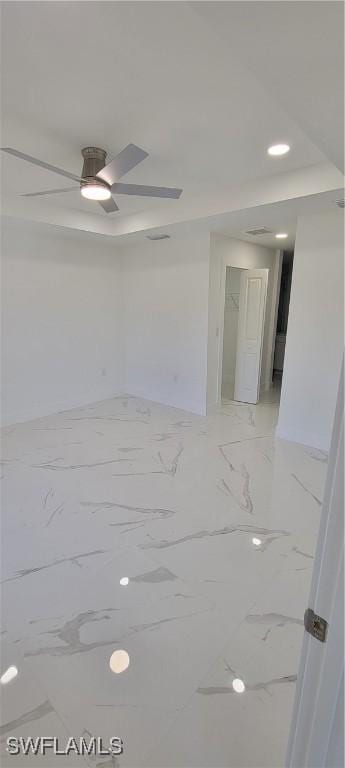 spare room featuring marble finish floor, ceiling fan, and recessed lighting