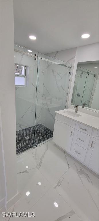 full bathroom featuring recessed lighting, marble finish floor, vanity, and a marble finish shower