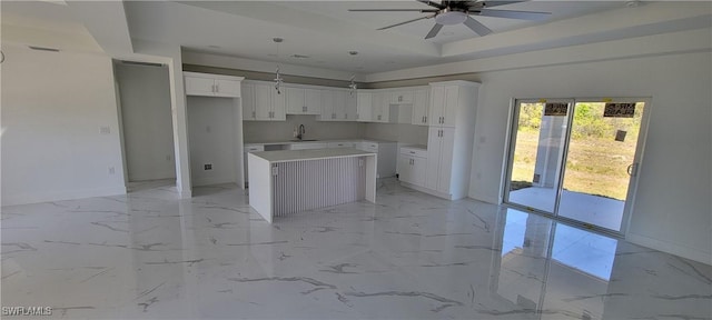 1025 Pilgrim St E, Lehigh Acres, FL 33974 - kitchen with a center island, baseboards, a sink, ceiling fan, and light marble finish floors