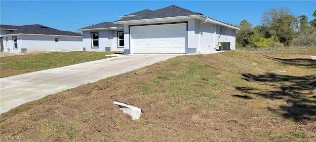 1025 Pilgrim St E, Lehigh Acres, FL 33974 - view of front of house featuring driveway, a garage, stucco siding, central AC, and a front yard