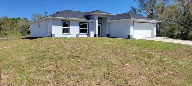 view of front of home featuring a front yard, an attached garage, and stucco siding