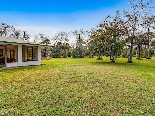 view of yard featuring a sunroom