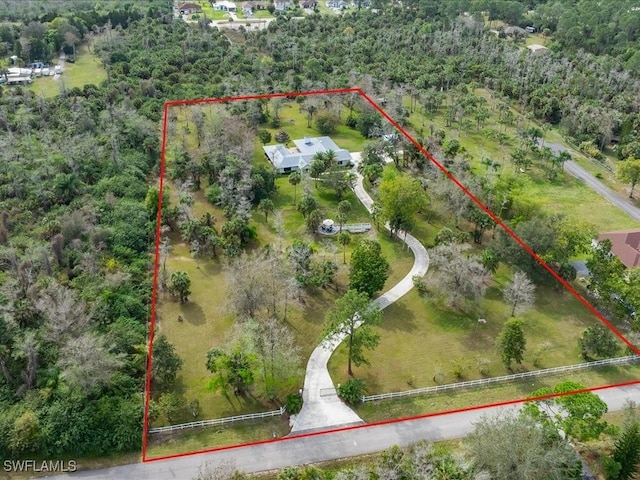 birds eye view of property with a wooded view