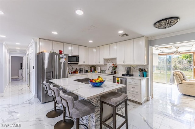 kitchen with appliances with stainless steel finishes, marble finish floor, visible vents, and a sink