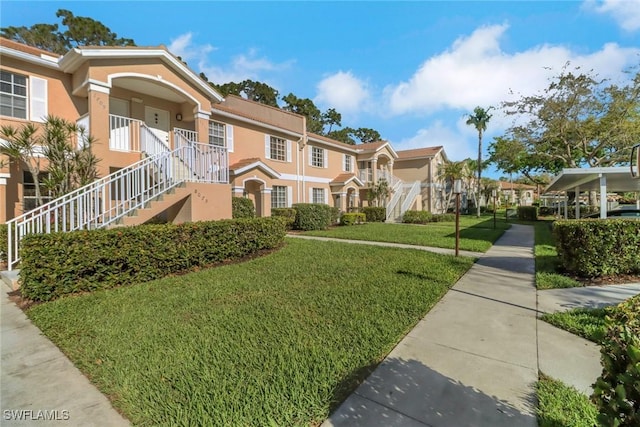 surrounding community with a residential view, a yard, and stairway