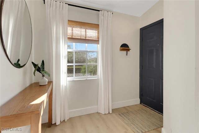 entrance foyer with light wood finished floors and baseboards