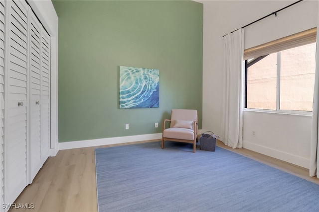 unfurnished room with light wood-type flooring and baseboards