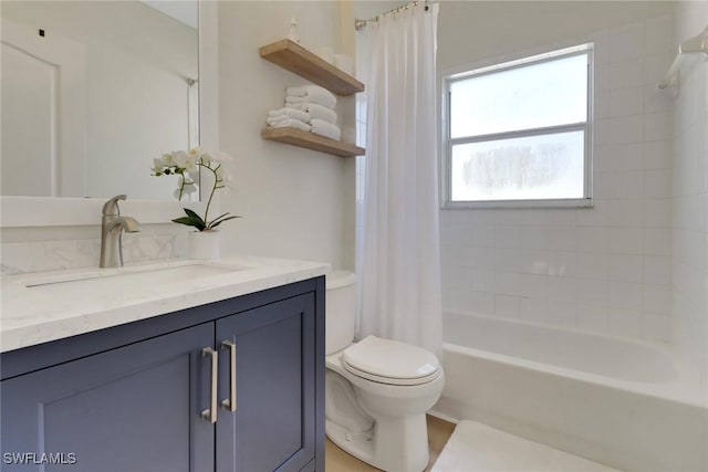 bathroom with toilet, shower / bath combination with curtain, and vanity