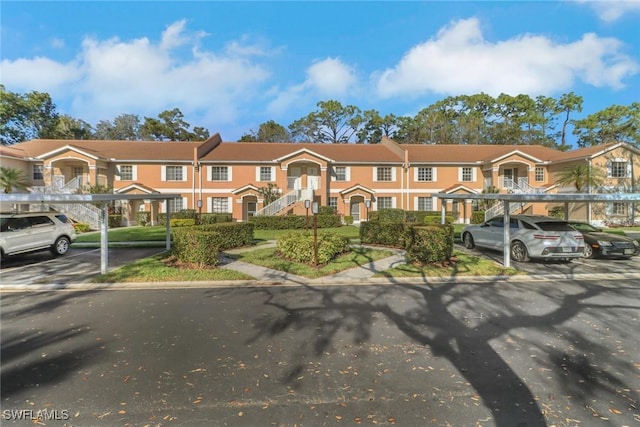 view of property featuring covered parking and a residential view