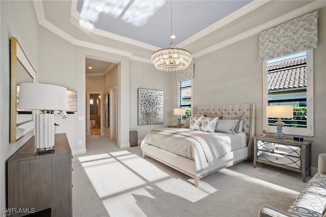 bedroom with baseboards, ornamental molding, a tray ceiling, carpet floors, and a notable chandelier