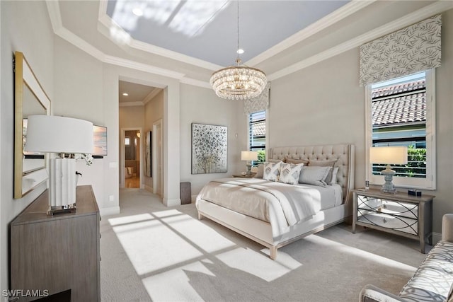 bedroom featuring baseboards, a tray ceiling, ornamental molding, carpet floors, and an inviting chandelier