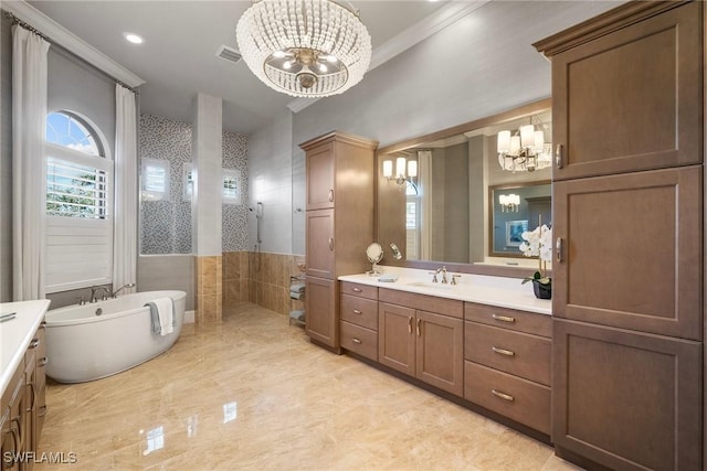 full bath with visible vents, walk in shower, a freestanding tub, a notable chandelier, and vanity