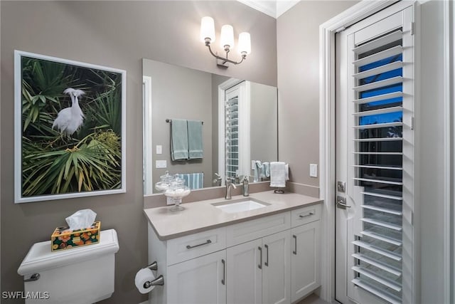 bathroom with toilet, beverage cooler, and vanity