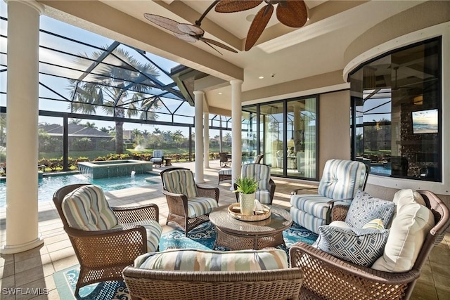 view of patio with a lanai, an outdoor hangout area, a pool with connected hot tub, and ceiling fan