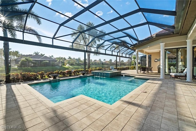 view of swimming pool with a patio, glass enclosure, and a pool with connected hot tub