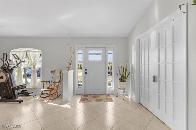 entrance foyer featuring light tile patterned floors and baseboards