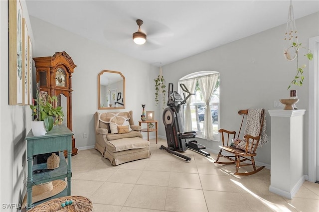 sitting room with light tile patterned floors, ceiling fan, and baseboards