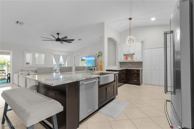 kitchen with visible vents, vaulted ceiling, stainless steel appliances, white cabinetry, and a wealth of natural light