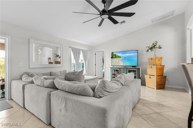 living room with light tile patterned floors, visible vents, vaulted ceiling, and a ceiling fan