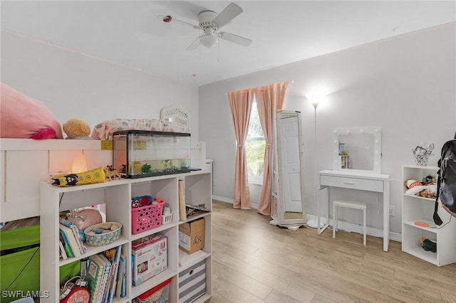 playroom featuring ceiling fan, baseboards, and wood finished floors