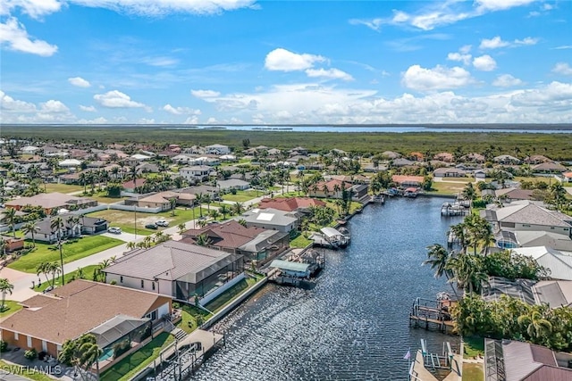 birds eye view of property with a residential view and a water view