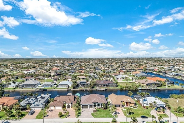 drone / aerial view featuring a residential view and a water view