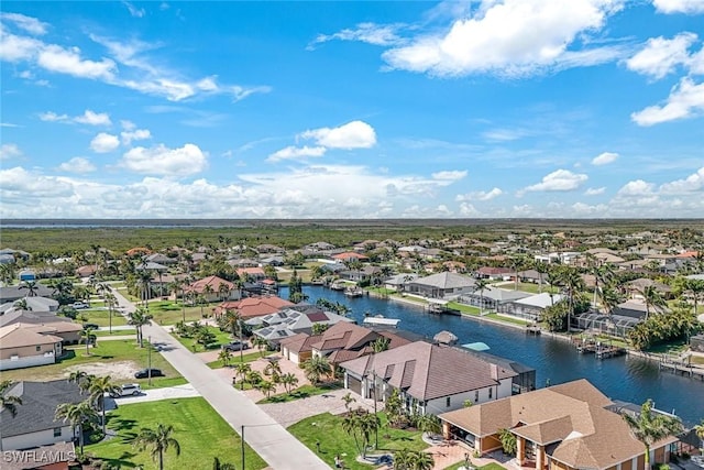 drone / aerial view with a residential view and a water view