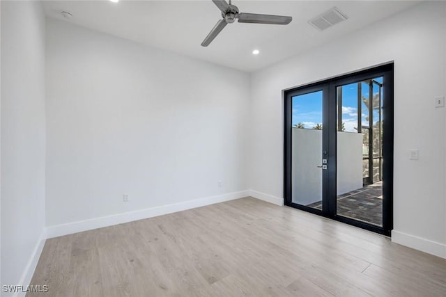 spare room with visible vents, wood finished floors, recessed lighting, french doors, and baseboards