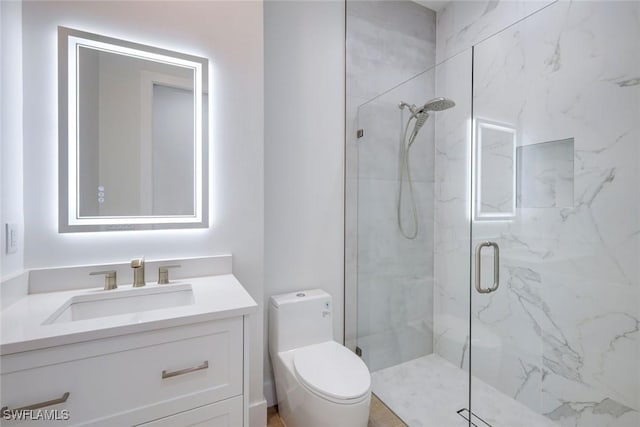 full bath with vanity, toilet, and a marble finish shower