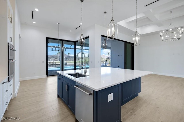 kitchen with light wood-style flooring, a sink, blue cabinetry, coffered ceiling, and stainless steel appliances