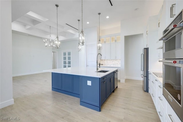 2811 SW 34th Ter, Cape Coral, FL 33914 - kitchen with blue cabinets, recessed lighting, light wood-type flooring, backsplash, and white cabinets