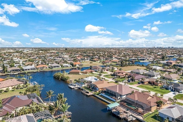 drone / aerial view featuring a residential view and a water view