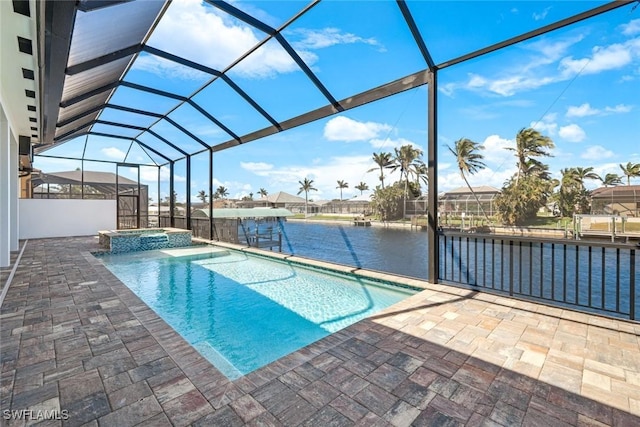 view of pool with glass enclosure, a patio, a pool with connected hot tub, and a water view