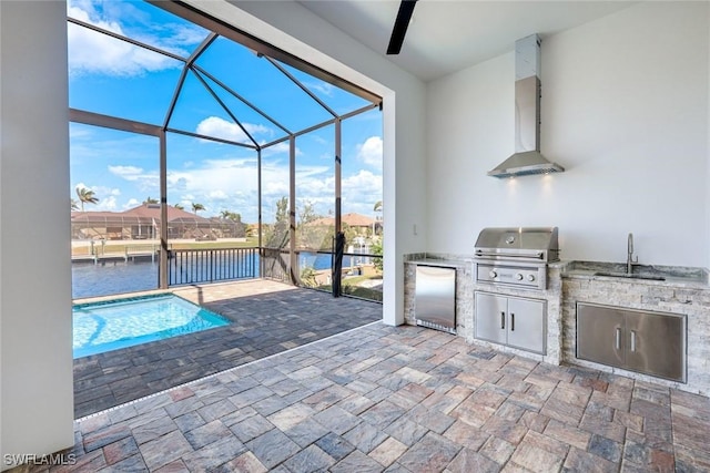 view of patio / terrace with a sink, an outdoor kitchen, a grill, an outdoor pool, and a lanai