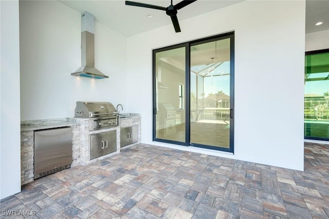 view of patio / terrace featuring ceiling fan, area for grilling, exterior kitchen, and a sink